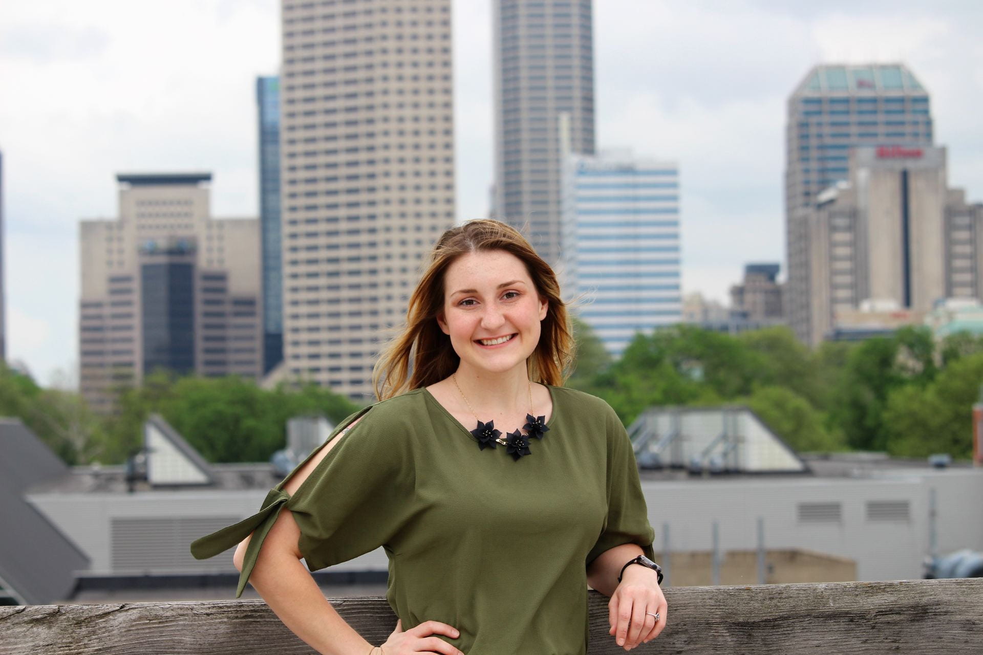 Cassie Popplewell stands with Indy skyline behind
