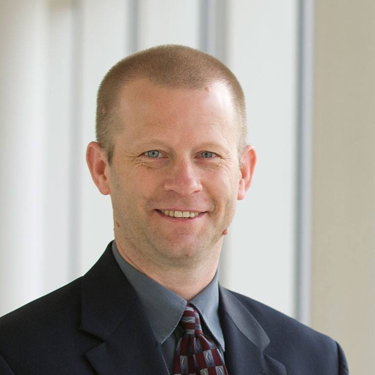 headshot of Doug Noonan wearing suit and tie