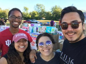 Group of young adults stand at food donation drive