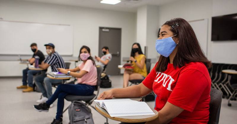 IUPUI students sitting in classroom at desks wearing masks