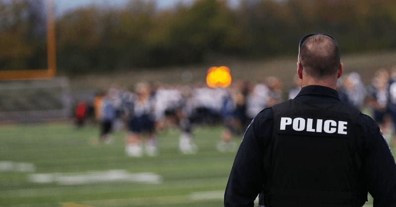 image of police officer at high school football game