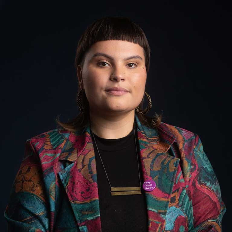 Photo of Harper Morgan with black background and floral jacket