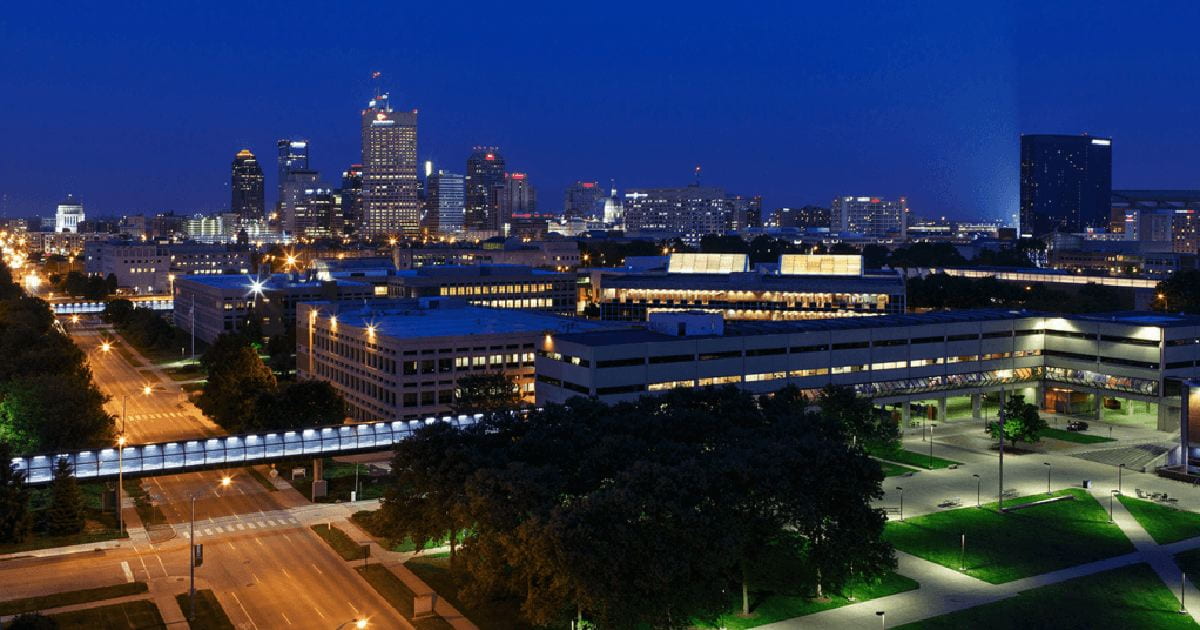 IUPUI campus at night with Indianapolis backdrop.