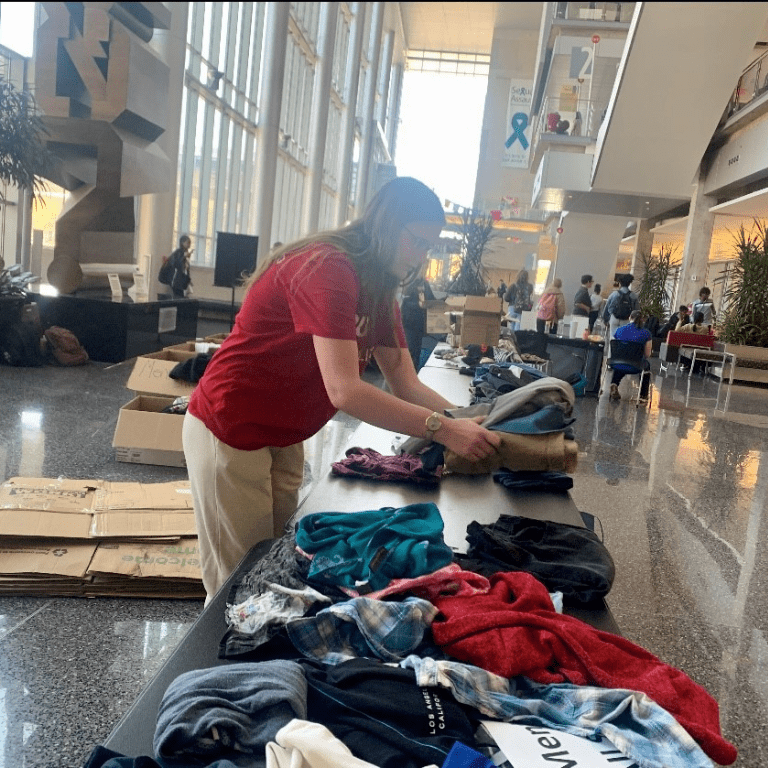 Carli Richard organizes items during the Stuff Swap at the Campus Center (2023).