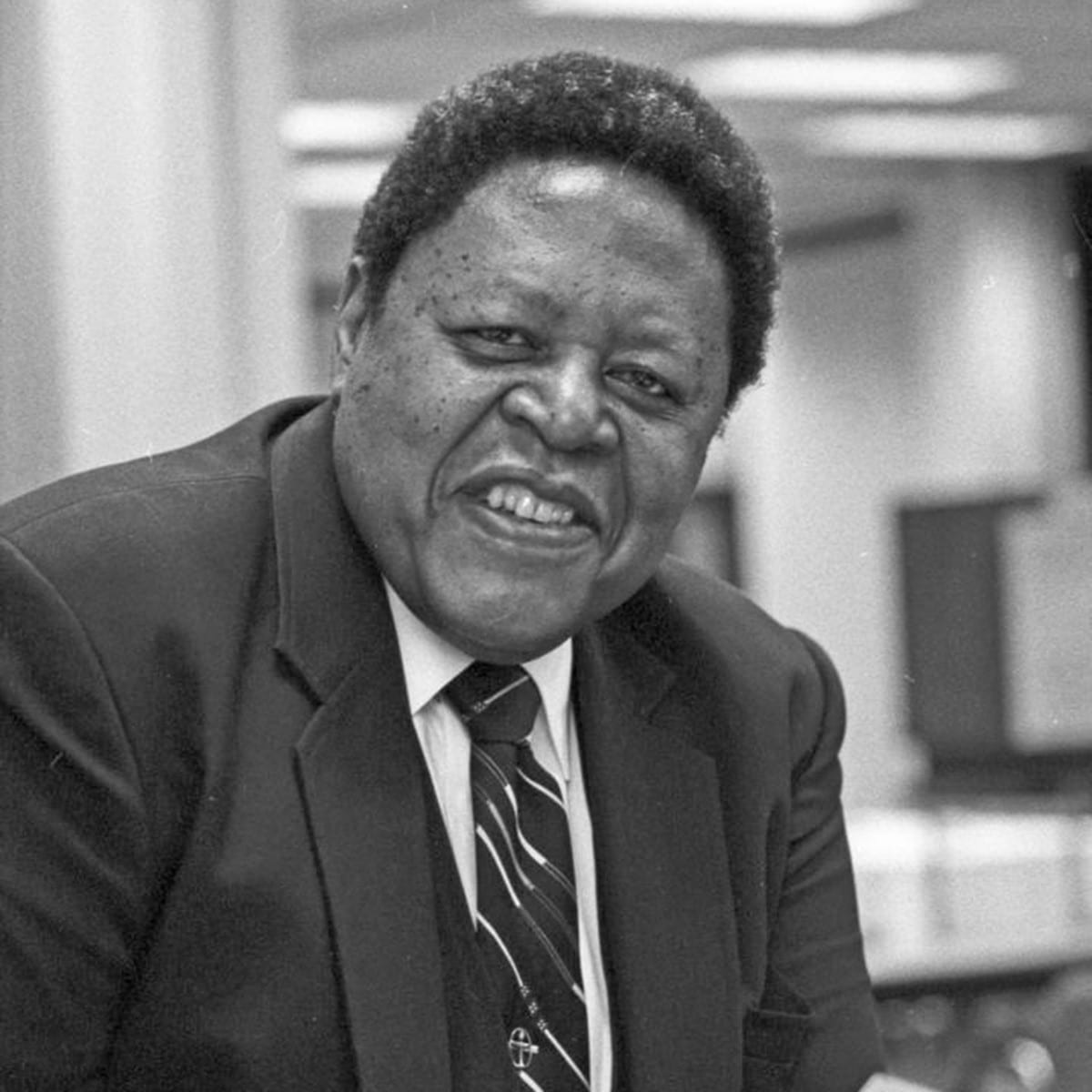 Black and white photo of Philip J. Rutledge, smiling