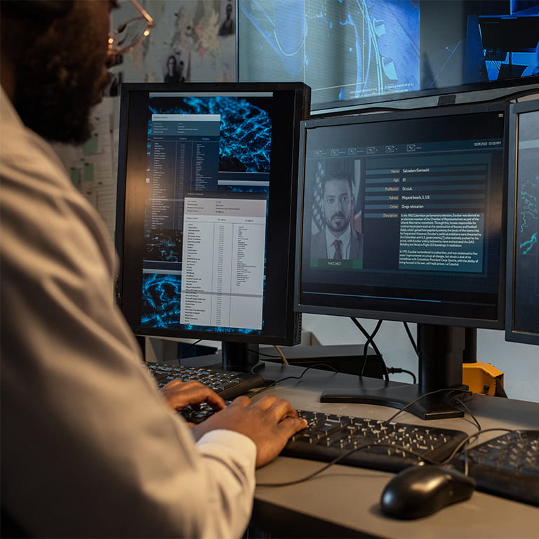 Computer screens showing information about a person in an investigation